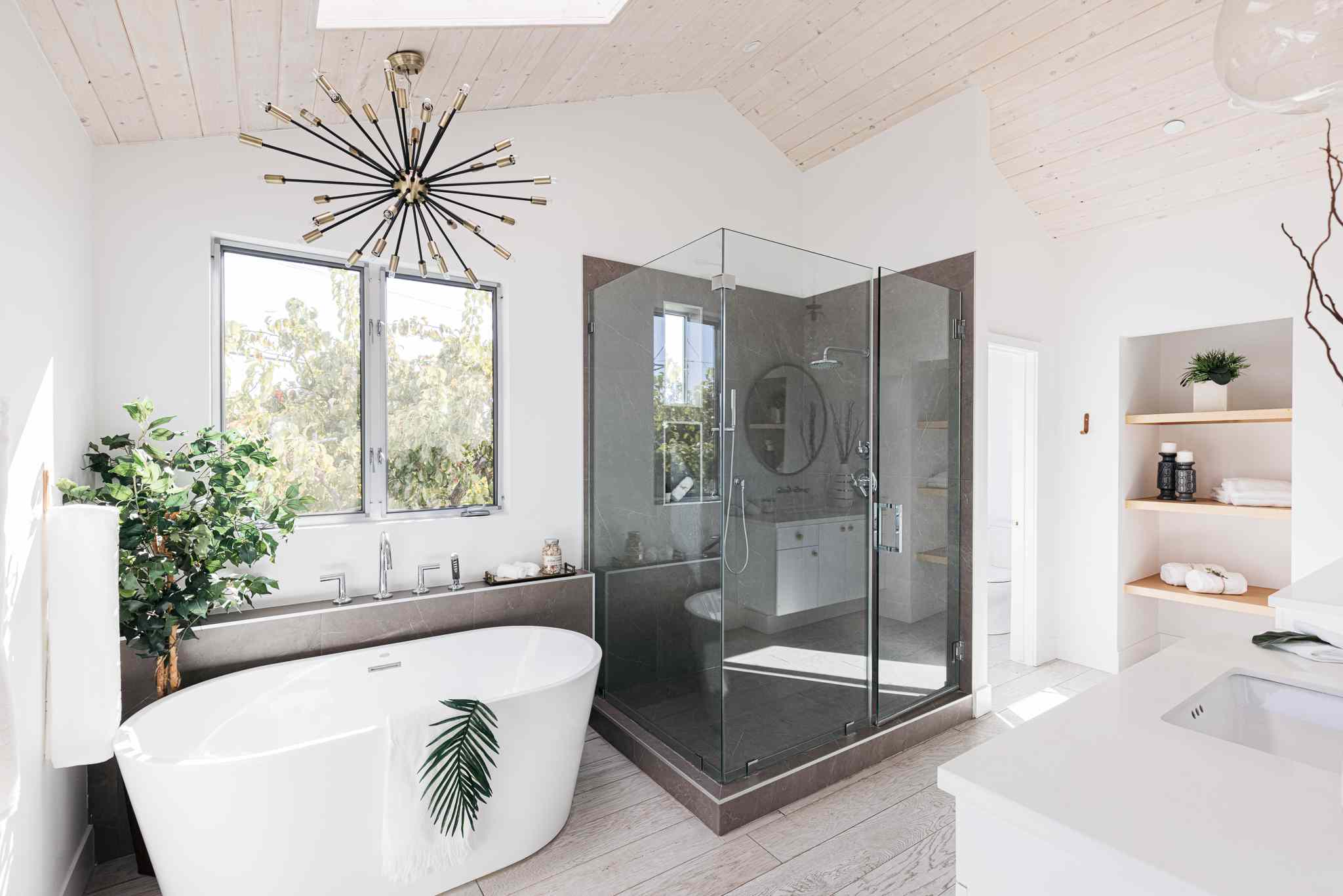 Modern bathroom with spa-inspired features such as rainfall showerhead, deep soaking tub, and heated floors